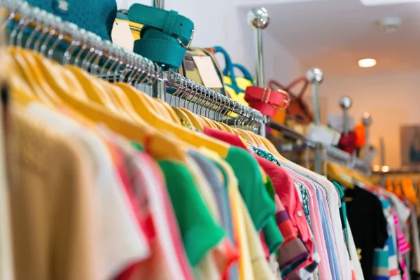 Variety of clothes hanging on rack — Stock Photo, Image