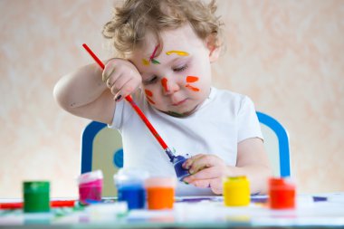 Cute little child painting