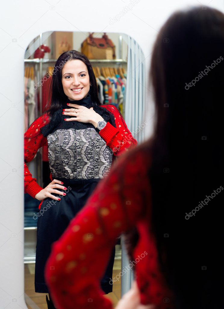 Young girl trying new dress in fitting room