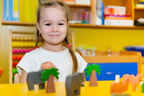 Cute little girl playing in kindergarten — Stock Photo, Image