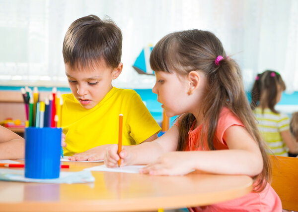 Group of cute little prescool kids drawing