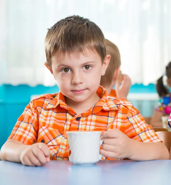 Cute little child drinking milk — Stock Photo, Image