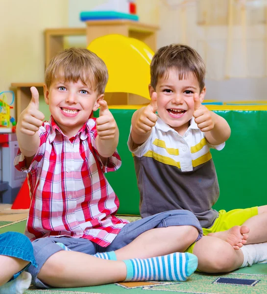 Niños emocionados sosteniendo pulgares hacia arriba — Foto de Stock