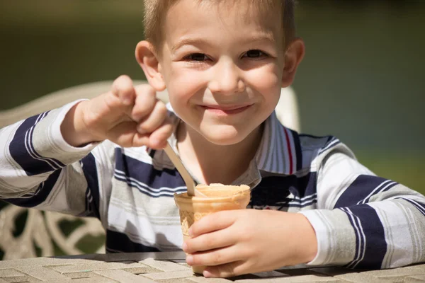 アイス クリームを食べる小さな男の子の笑みを浮かべてください。 — ストック写真