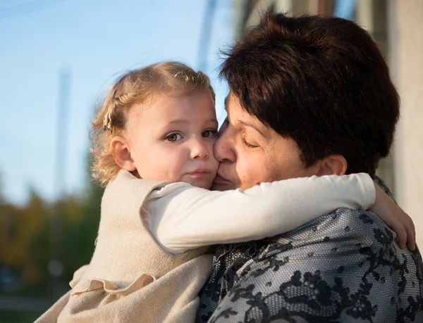 Little girl embracing with grandmother — Stock Photo, Image
