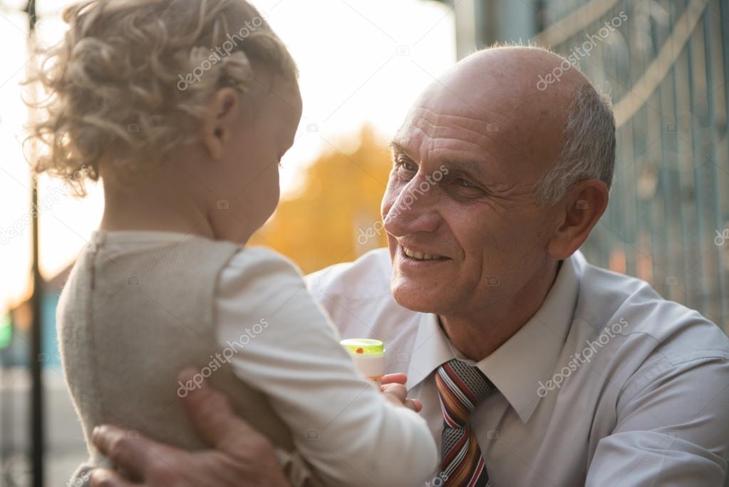 Happy grandfather with granddaughter