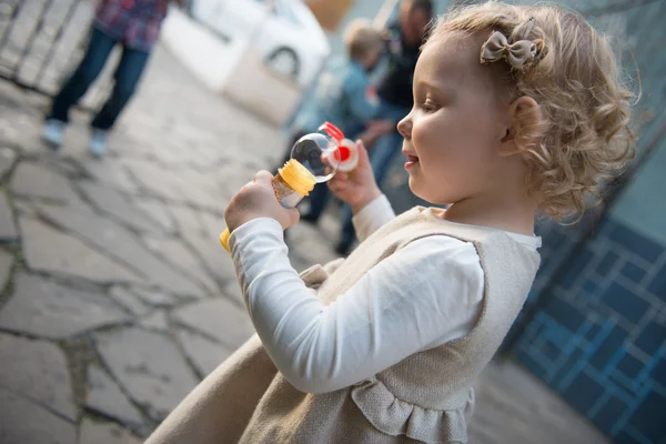 Cute little girl dmuchanie bańki mydlane — Zdjęcie stockowe