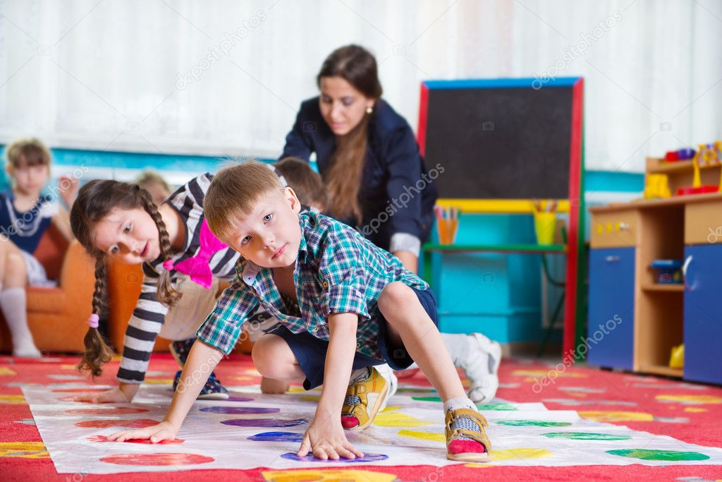 Cute toddlers playing in twister game