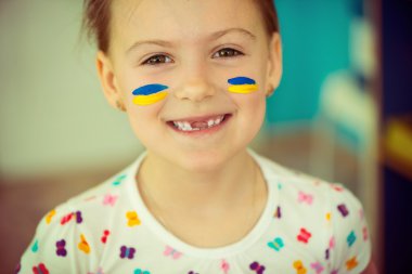Ukrainian girl with national flag on cheek clipart