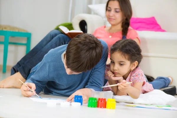 Dos niños pintando con pinturas de colores en casa — Foto de Stock