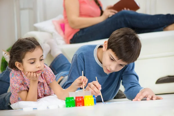 Two children painting with colorful paints at home — Stock Photo, Image