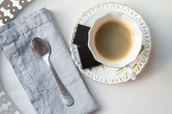 在自助餐厅的漂亮的白盘上 放着一杯别致的浓缩咖啡和黑巧克力 — 图库照片