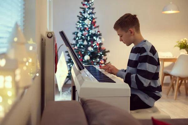 Tennage Ragazzo Pratica Treccia Pianoforte Casa Con Albero Capodanno Sullo — Foto Stock