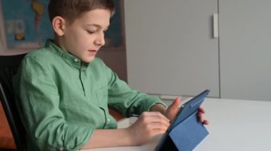 4K 60fps video uzaktan öğrenme tablet kullanarak evde oturan genç çocuk