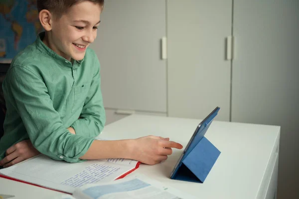 学校でのオンラインレッスン中に彼の友人とチャットする笑顔の少年 — ストック写真