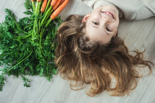 Sorrindo Menina Feliz Adolescente Deitada Chão Com Monte Cenouras Laranja — Fotografia de Stock