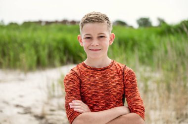 Portrait of handsom teen boy on beautiful white beach at summer holidays