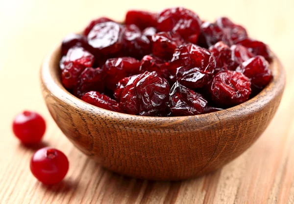 Dried cranberries in a wooden plate — Stock Photo, Image