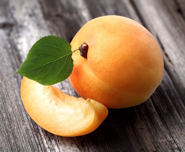 Ripe apricot on a wooden background — Stock Photo, Image