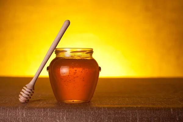 Glass honey jar with dipper — Stock Photo, Image