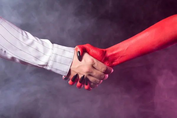 Businessman making a deal with devil — Stock Photo, Image