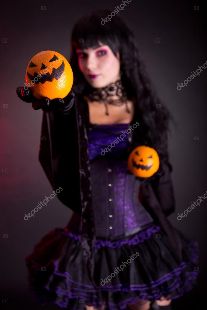 Beautiful witch in purple gothic Halloween costume — Stock Photo