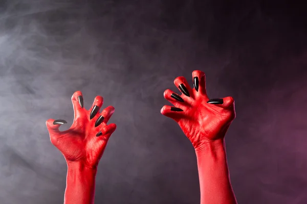 Spooky red devil hands with black glossy nails — Stock Photo, Image