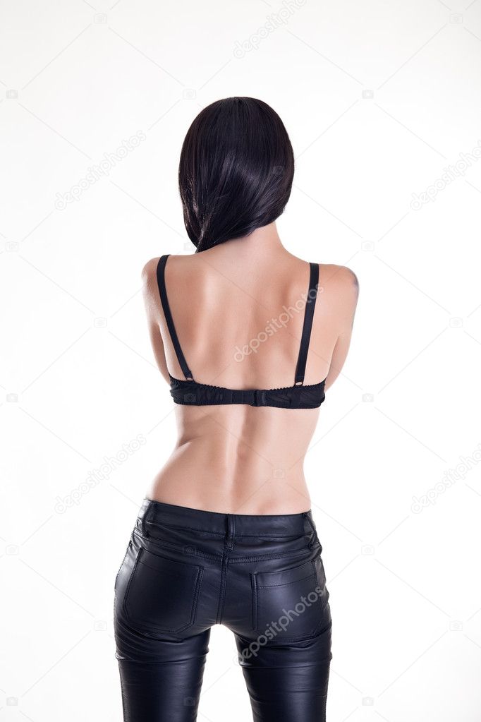 Rear view of beautiful woman wearing leather pants