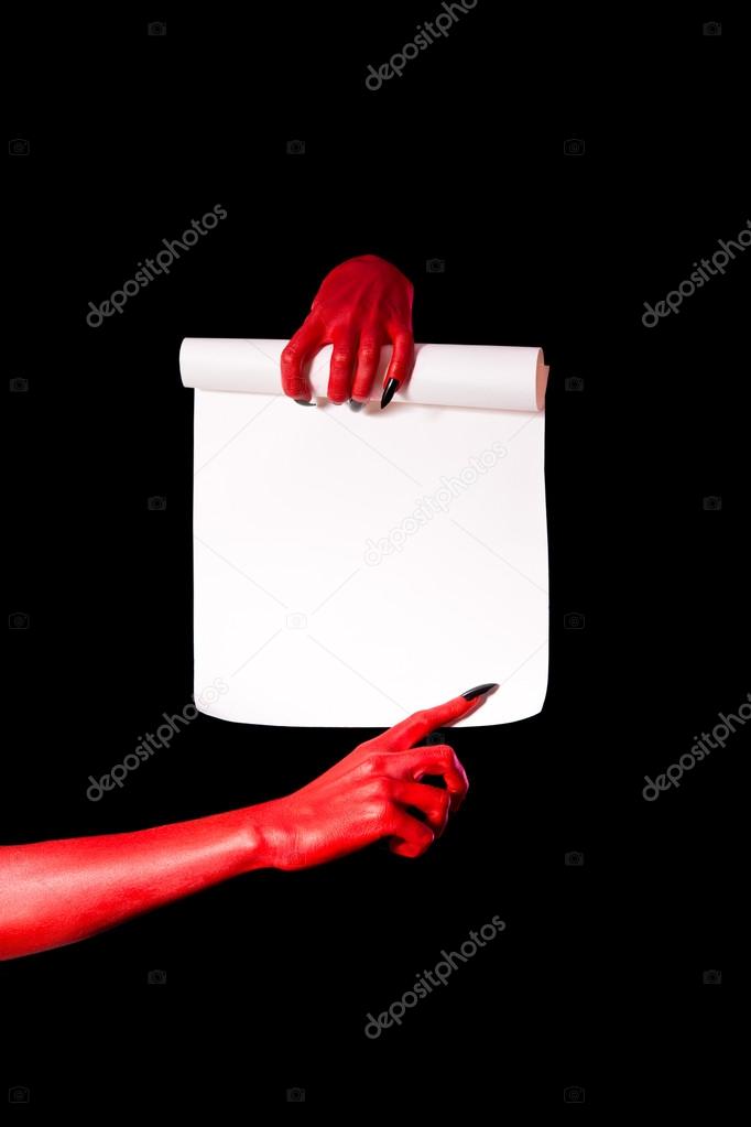 Red devil hands with black nails holding paper scroll