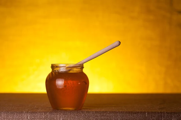 Honey jar on canvas table — Stock Photo, Image