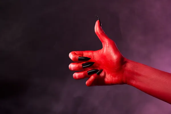 Mano roja del diablo mostrando pulgares hacia arriba — Foto de Stock