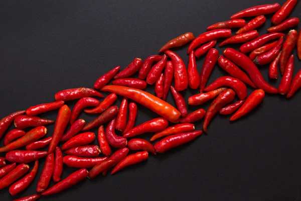 Row of non-stem red bird eye chili peppers — Stock Photo, Image