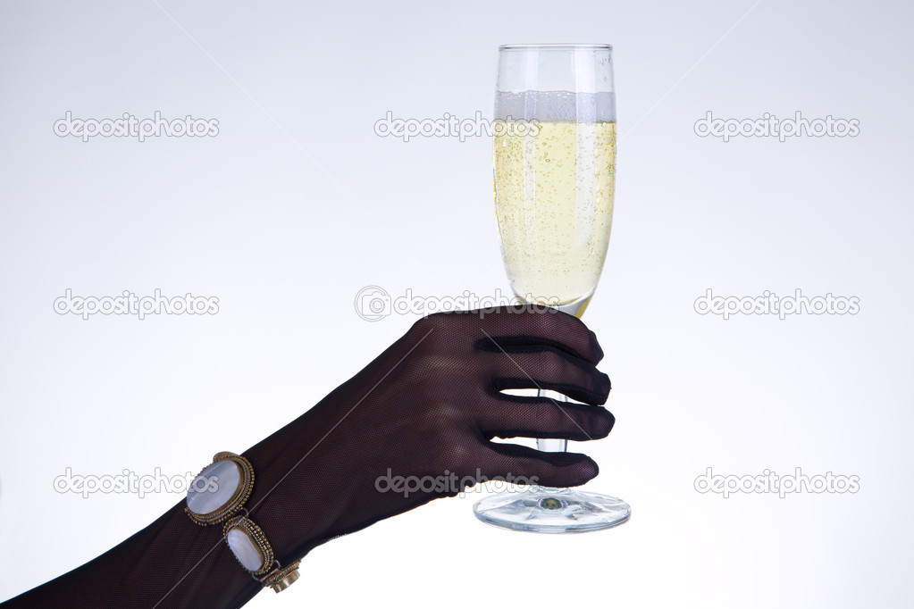 Female hand holding champagne glass