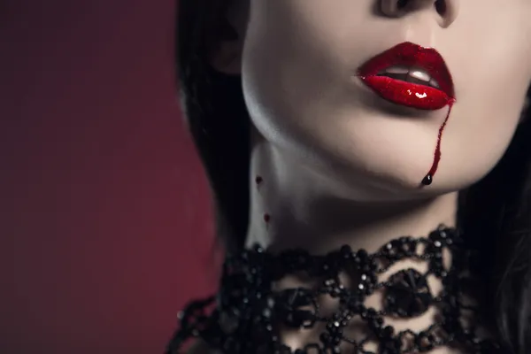 Sensual young woman with red lips bitten by vampire — Stock Photo, Image