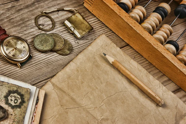 Old notes and coins and abacus on a wooden table