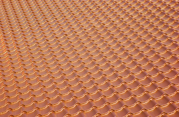 Terracotta metal tile roof, background
