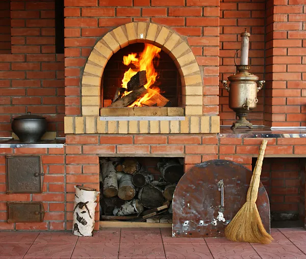 Russian interior kitchen with an oven and a burning fire — Stock Image Russian interior kitchen with an oven and a burning fire Stock Photo