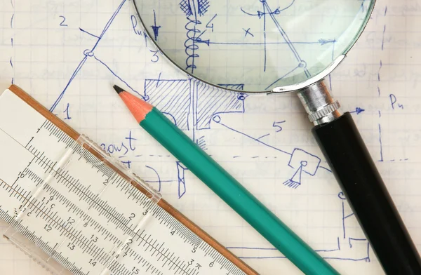 magnifying glass and a slide rule on the old page with the calcu