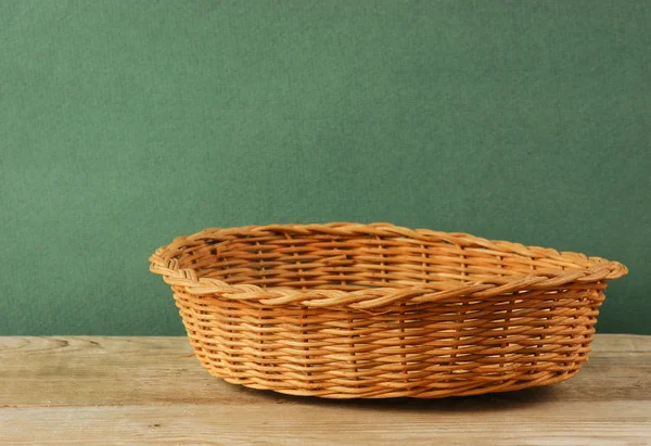 empty wicker basket on an old wooden table