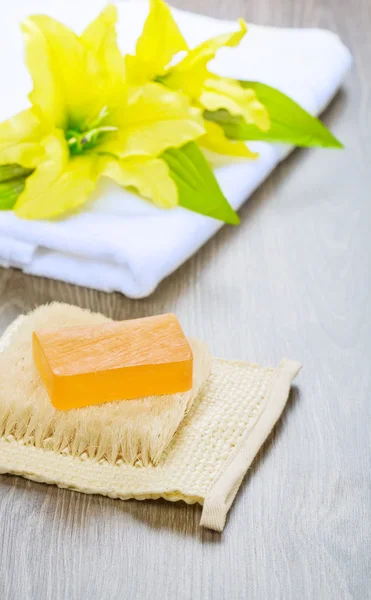 Flower on towel and soap on bast — Stock Photo, Image