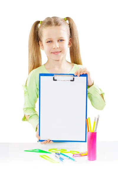 A schoolgirl holding paperclip near table — Stock Photo, Image