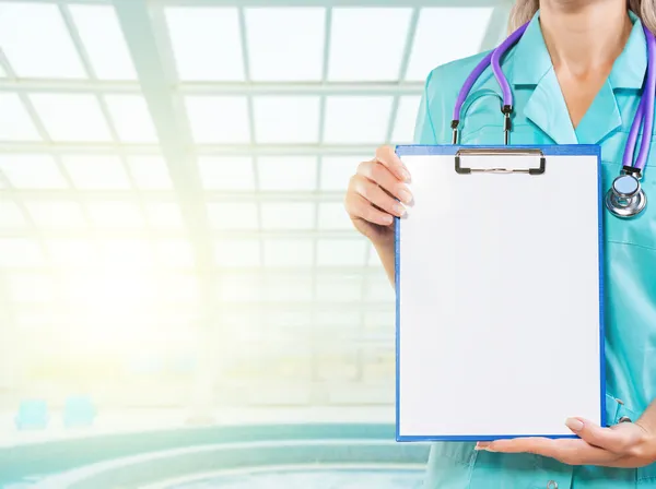 Clipboard in hands of female doctor — Stock Photo, Image