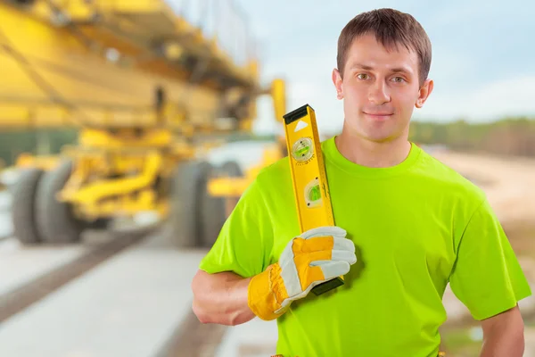 A worker with costruction level — Stock Photo, Image