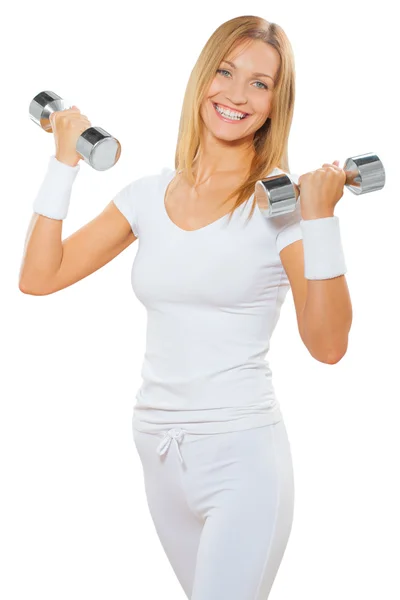 A fitness female holding two dumbbells and smiling — Stock Photo, Image