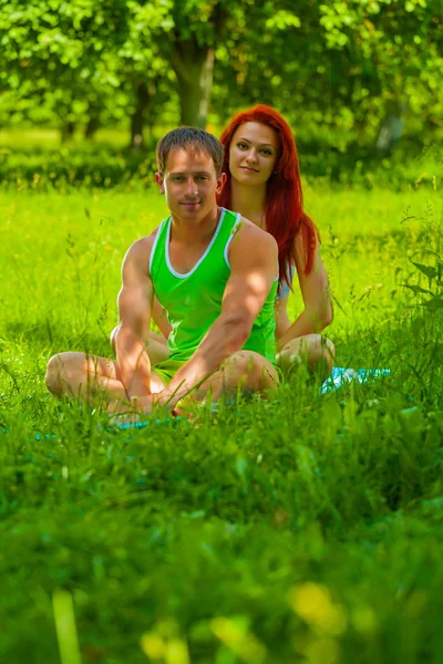 Paar sitzt auf Gras — Stockfoto