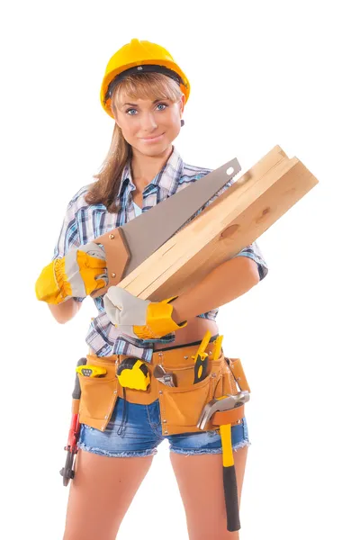 Half length portrait of happy female construction worker with handsaw and wooden planks and tool belt — Stock Photo, Image