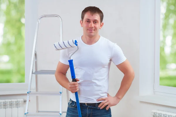 Young man with paintroller — Stock Photo, Image