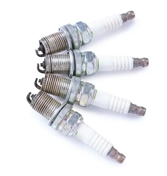 Set of four used sparks plugs — Stock Photo, Image