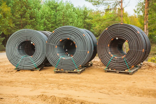 Rolls of pipes in forest — Stock Photo, Image