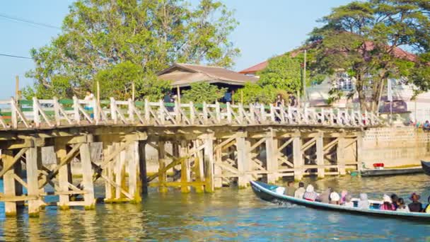 NYAUNGSHWE, MYANMAR - CIRCA JAN 2014: Large wooden bridge across the river. The bridge withstands cargo transport — Stock Video
